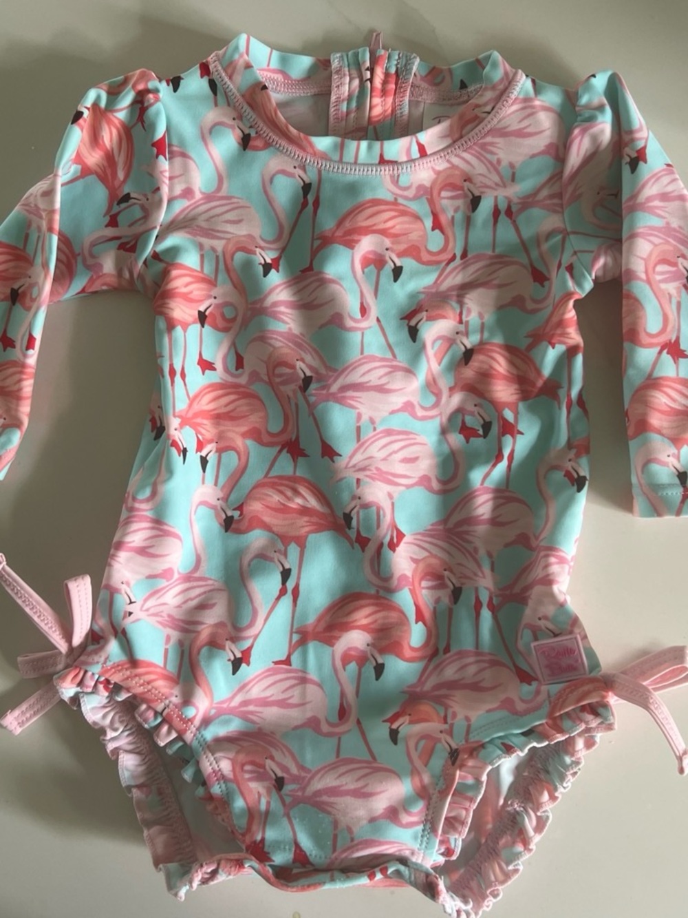 Ruffle Butts Pink Flamingo Print Long Sleeve One-Piece on Aqua
